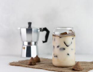 Cold coffee with milk on a matted napkin