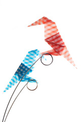 Obraz premium Colored origami Birds on a perch isolated over white background.