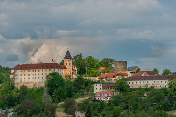 Fototapeta na wymiar Castle on big hill in Vimperk town in spring sunny and cloudy day