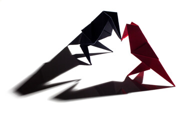 Bird origami made from colored paper isolated over black background