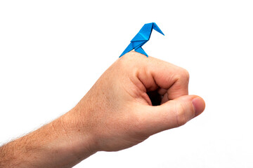 Hand holds an Origami bird made of colored paper isolated on white background