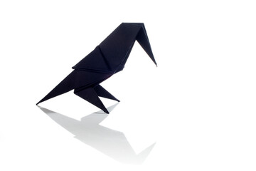 Origami bird made of colored paper isolated on white background