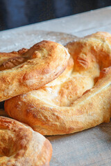 Armenian national matnakash bread. Part view of three loaves of bread on kitchen table

