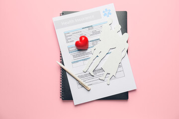 Family figures and health insurance form on color background