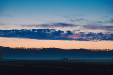 Sunrise in the field. Beautiful morning sky landscape, foggy meadow in village.