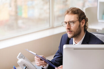 Handsome young man working in office