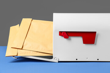 Mail box with letters on color background