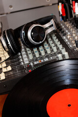 Old fashioned music sound mixer with headphones. Professional audio mixing console for DJ with...