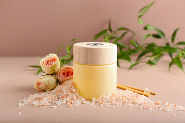 Reed diffuser with roses and sea salt on color background