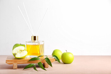 Reed diffuser with apples on table