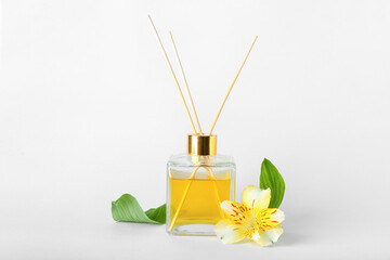 Reed diffuser with alstroemeria on white background