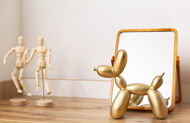 Stylish decor on shelf near light wall