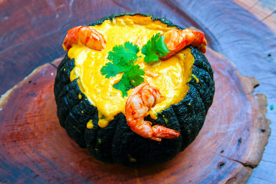 Prawns in Pumpkin (Camarao na Moranga) - Prawns with a creamy coconut milk sauce served inside a roasted pumpkin.