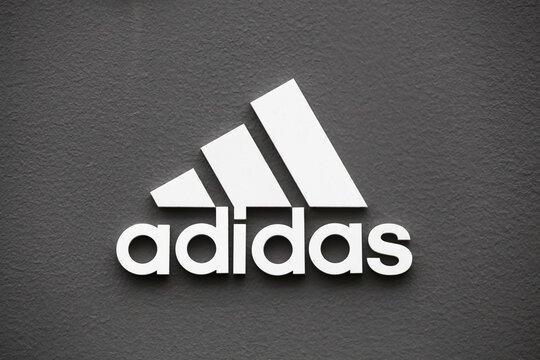 Copenhagen, Denmark - August 20, 2020: Adidas logo on a wall. Adidas is a German multinational that manufactures sports shoes, clothing. It is the second biggest sportswear manufacturer in the world