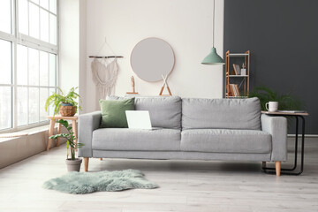 Stylish interior of living room with comfortable sofa