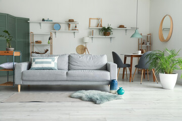 Stylish interior of living room with comfortable sofa
