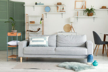 Stylish interior of living room with cozy sofa
