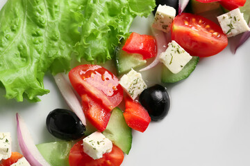 Tasty Greek salad on plate, closeup