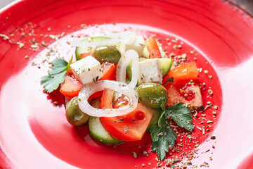 Tasty Greek salad on plate, closeup