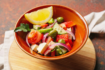 Bowl of tasty Greek salad on table
