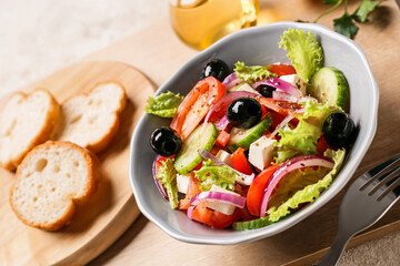 Bowl of tasty Greek salad on table