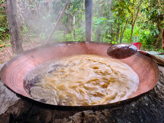 Boiling the sugarcane juice to make garapa, sugar and cachaça in a copper pot, ( Rapadura )