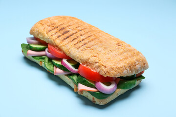 Tasty ciabatta sandwich on color background