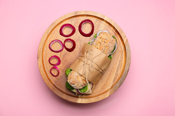 Board with tasty ciabatta sandwich on color background