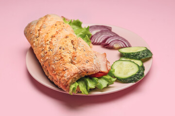 Plate with tasty ciabatta sandwich on color background