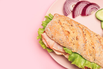 Plate with tasty ciabatta sandwich on color background