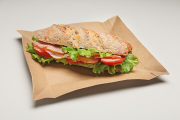 Tasty ciabatta sandwich on white background