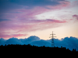 Power transmission tower in the blue cloudy sunset