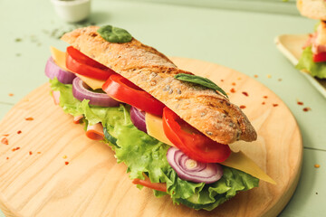 Tasty ciabatta sandwich on color wooden background