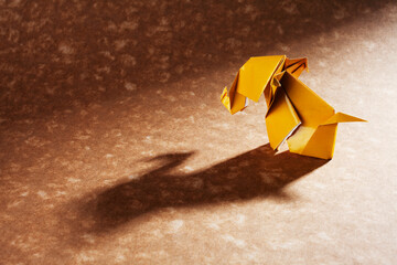 Origami elephants isolated on craft paper background.