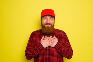 Delivery man with hat and beard has an happy expression