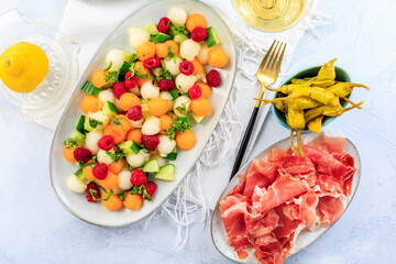 Cucumber and melon salad with raspberries and Prosciutto with grilled peppers