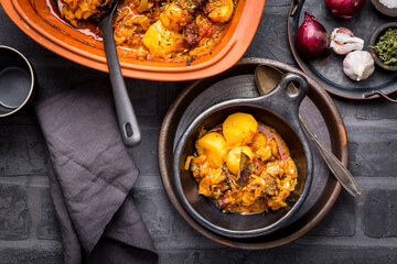 Goulash with potatoes and sauerkraut. Beef and vegetable stew in clay pot