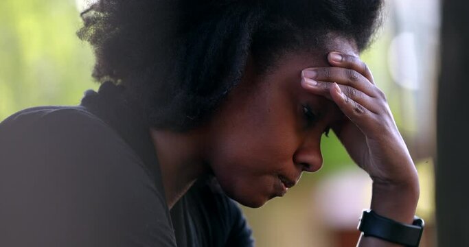 Frustrated Black woman shaking head in regret