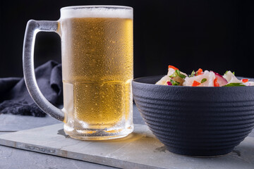 a mug of cold beer and a bowl of ceviche