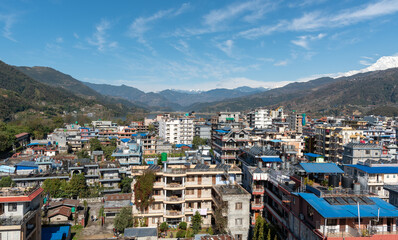 Fototapeta na wymiar Cityscape of Pokhara with the Annapurna mountain range covered in snow at central Nepal, Asia