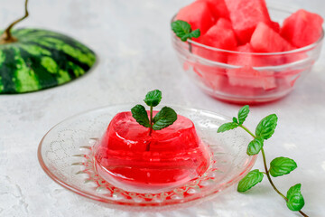 Homemade watermelon and mint dessert. Jelly in a glass plate on a light background.