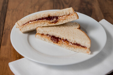 peanut butter and jelly sandwich triangles on white plate