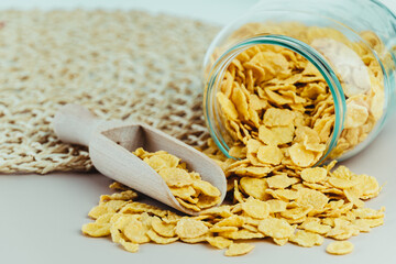 Close-up of glass jar full of healthy cornflakes.
