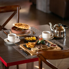 Set lunch or dinner in restaurant. fried potatoes, meat steak and set of sauces, served dishes with delicious hearty food on wooden table.
