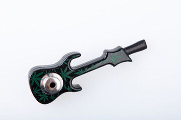 Beautiful cannabis pipe in the form of a guitar with hemp leaves drawings on it