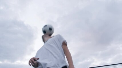 Closeup of young happy smiling amateur football players perform tricks with the soccer ball before to start a friendly match or training workout game on court in a sunny day. 4K RAW graded footage