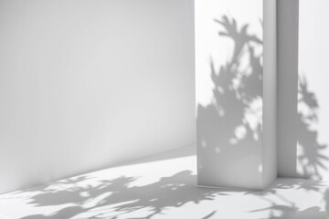 White table and abstract geometric wall background with flowers and palm leaves shadows overlay....