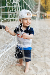 Portrait of a cheerful boy on a summer day. Beautiful child in a baseball cap.