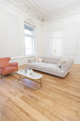 Fototapeta na wymiar very light baroque style luxury interior of big sitting room. White walls decorated with awesome stucco. Royal style apartment with chic furniture with gold elements