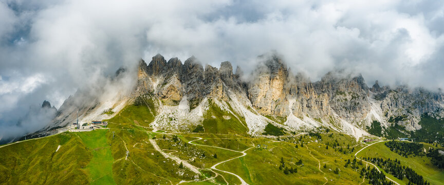 Aerial panoramic view of Pizes de Cir - Cirspitzen. Panorama in the Dolomites Mountanis in South Tyrol Italy. Mountains ridge with beautiful clouds, green alm meadows on a summer day